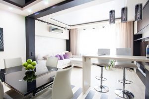 Kitchen and living room containing pendant lights and track lighting as examples of residential lighting in PA